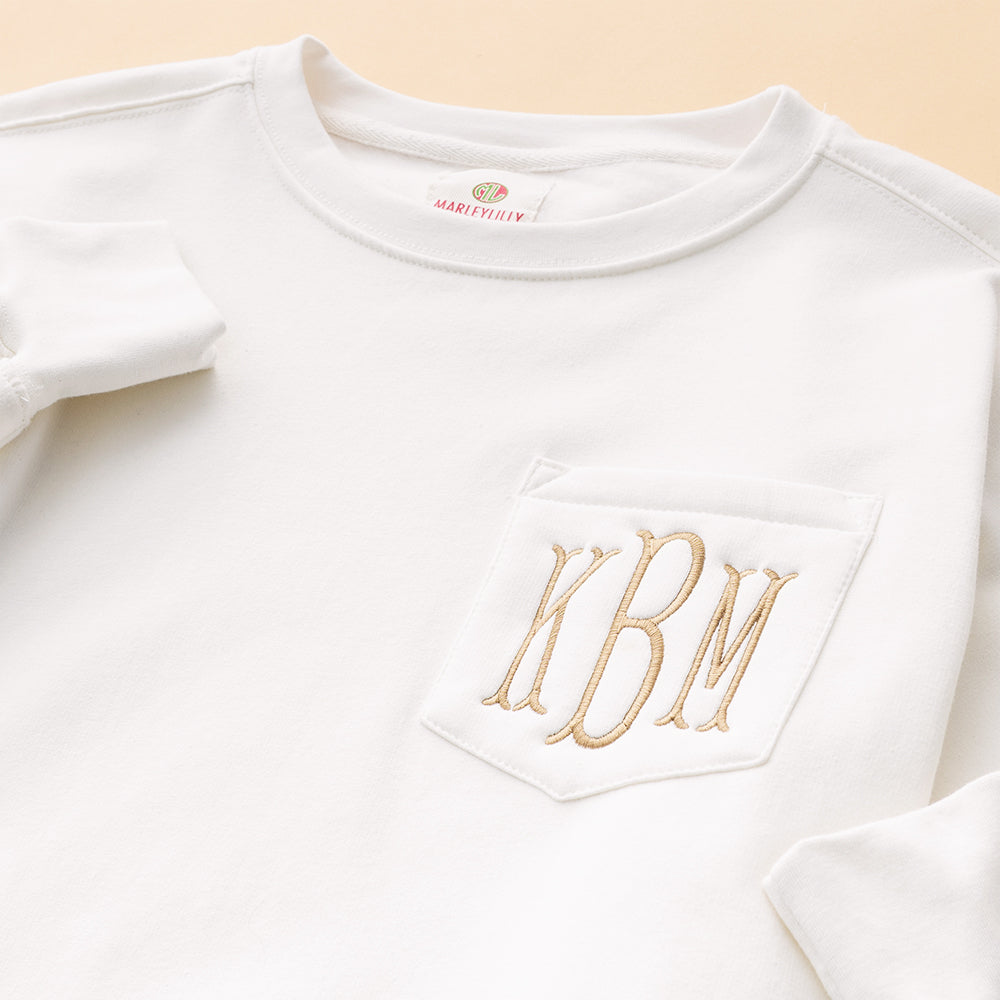 close up of ivory monogrammed oversized sweatshirt 