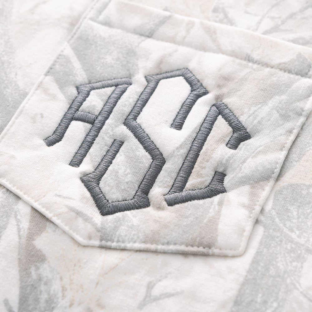 close up of monogram on birch camo oversized sweatshirt 