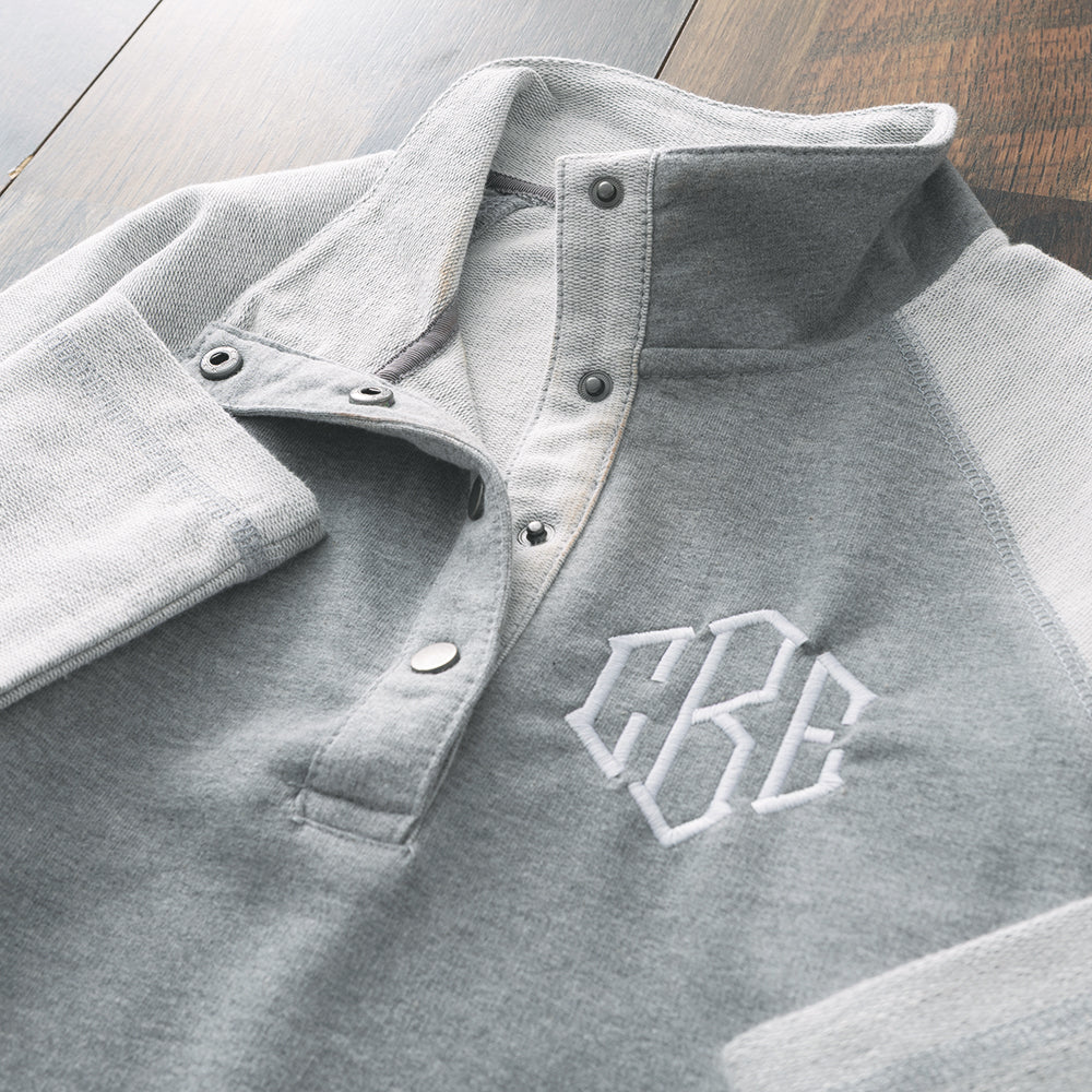 close up of monogrammed essential pullover in heathered grey fabric 