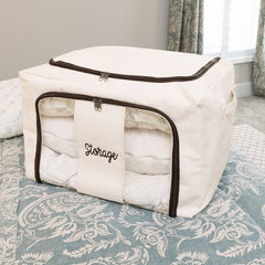 close up of monogrammed ivory storage bag on bed 
