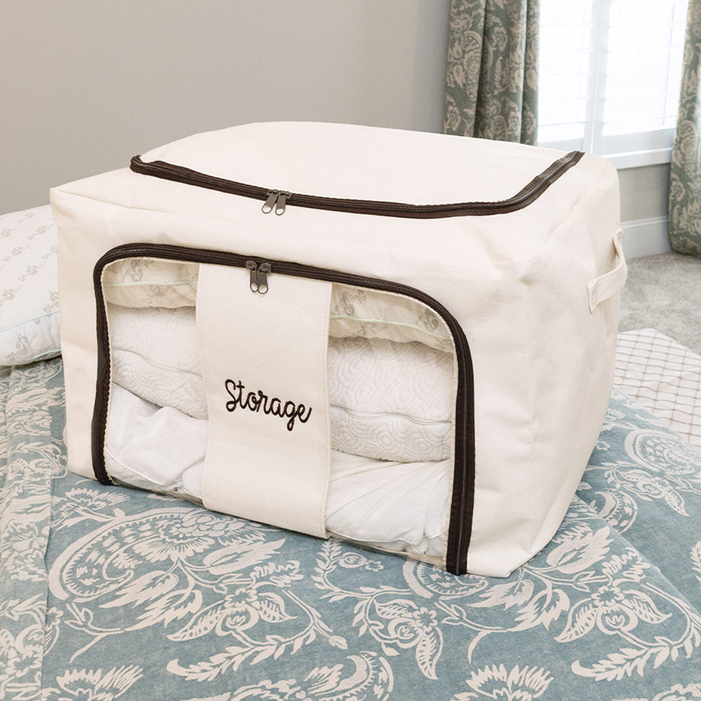 close up of monogrammed ivory storage bag on bed 