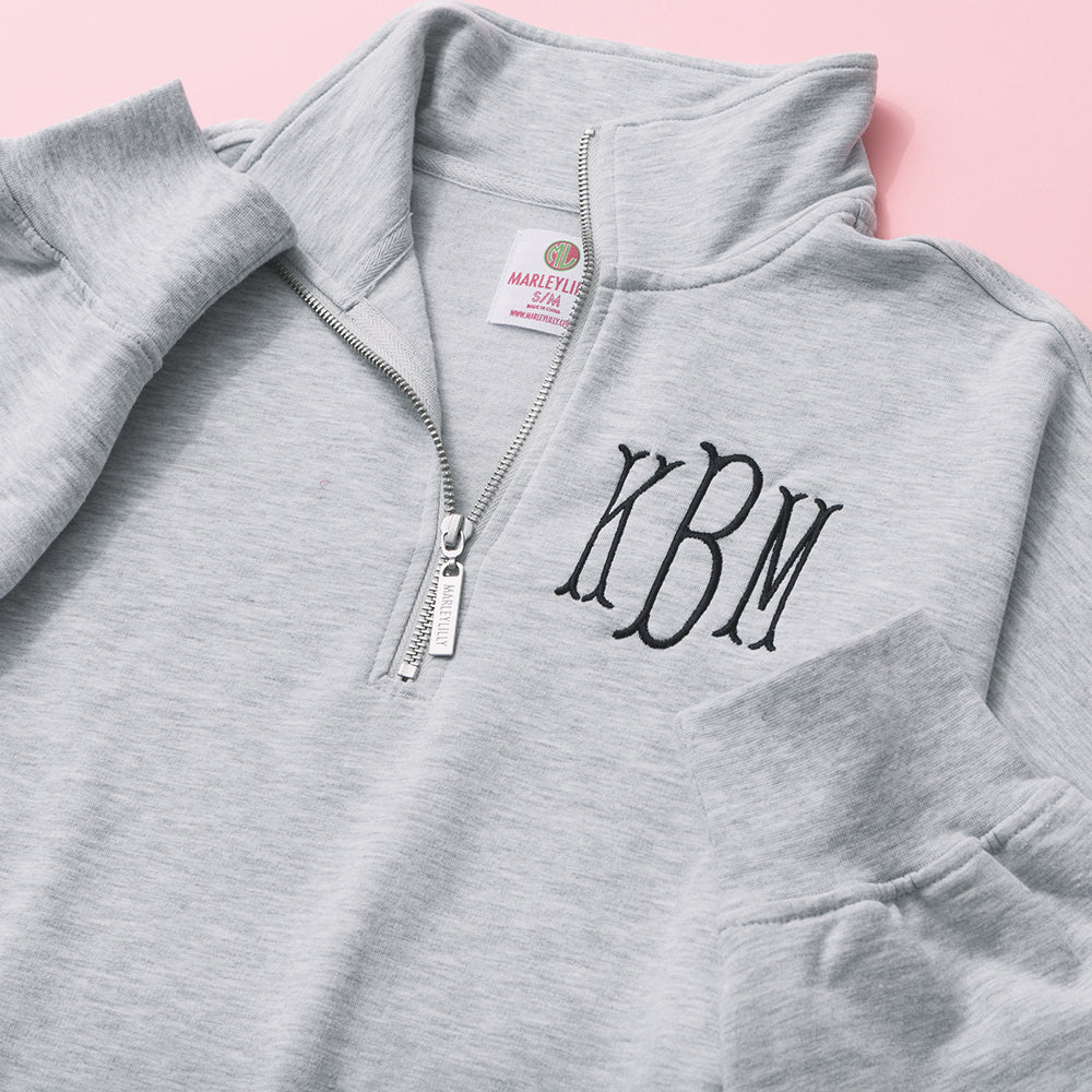 close up of monogrammed oversized quarter zip pullover in heathered grey 