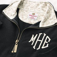 close up of monogrammed quarter zip sweatshirt in luxe leopard 