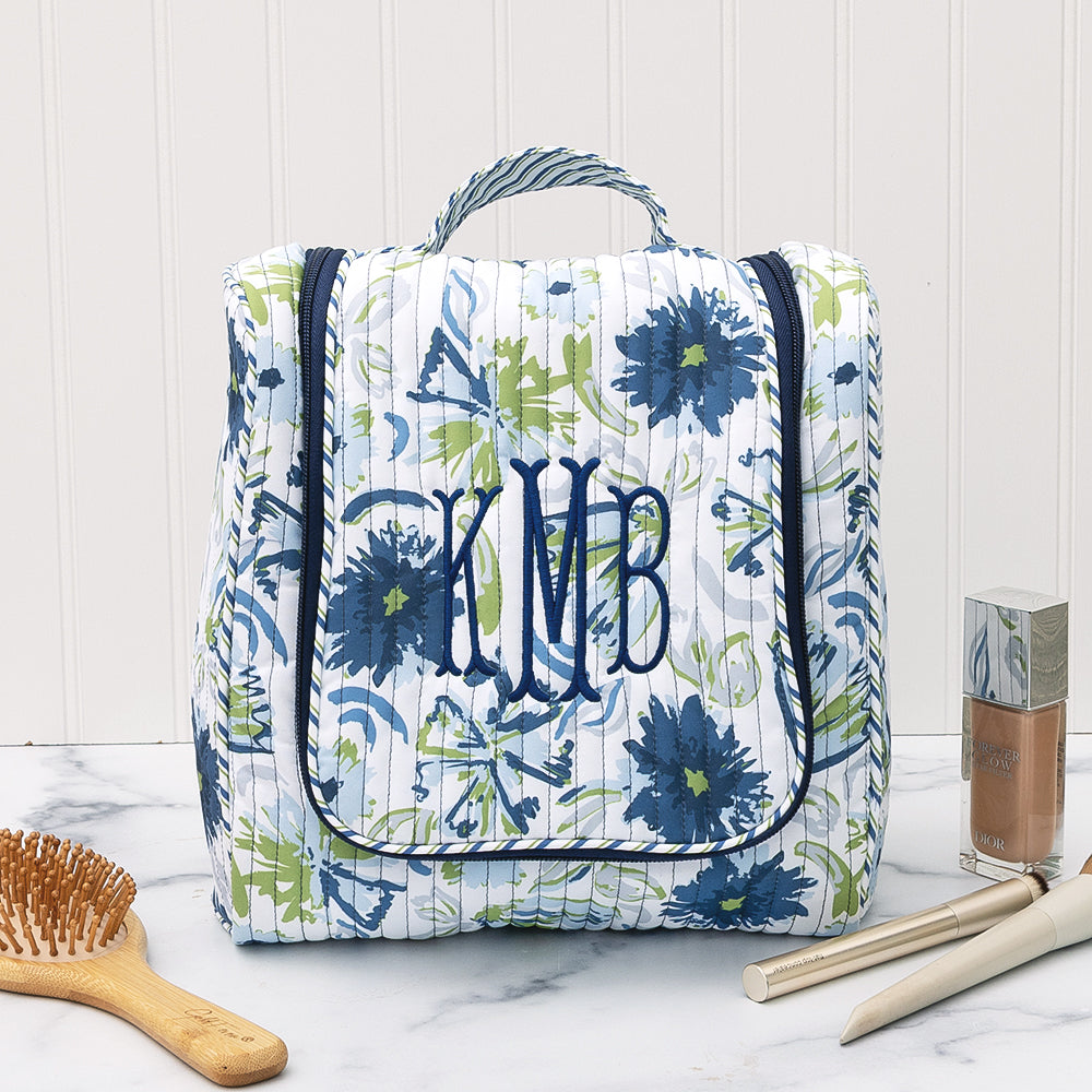 close up of monogrammed quilted hanging toiletry bag in indigo painted petals 