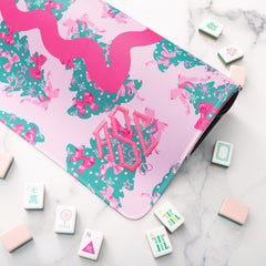 close up of pink christmas trees mahjong mat with tiles 
