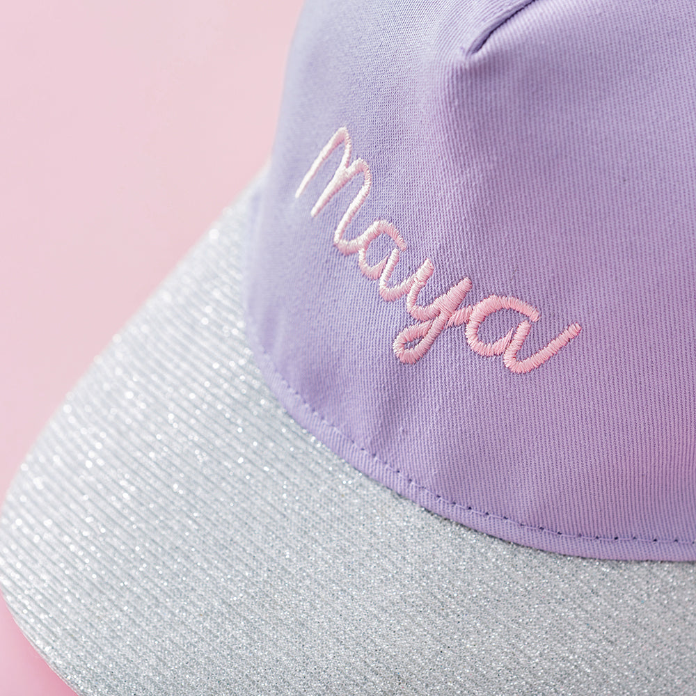 close up of purple monogrammed kids trucker hat 