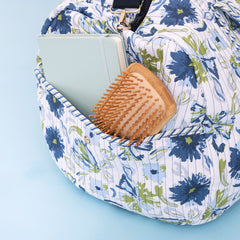 close up of quilted weekender in indigo painted petals 