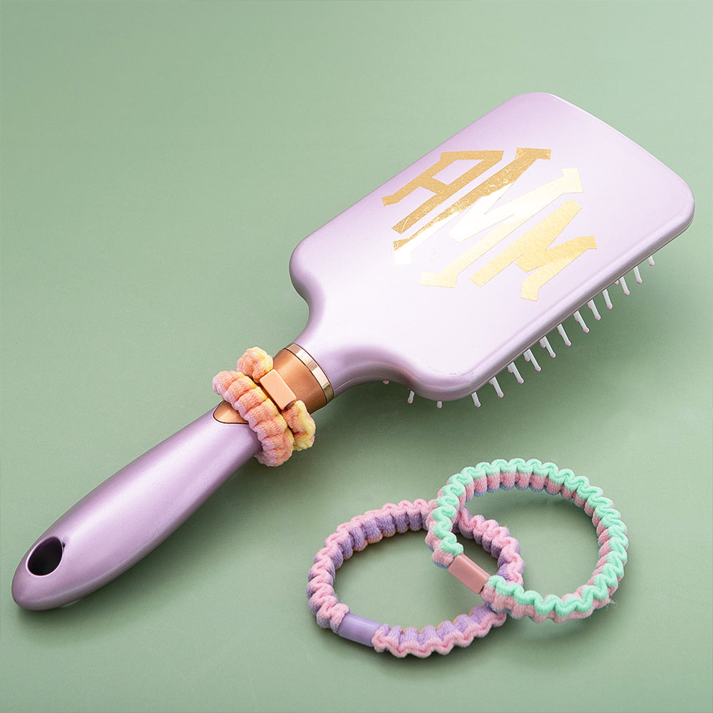 colorful hair ties set with hairbrush
