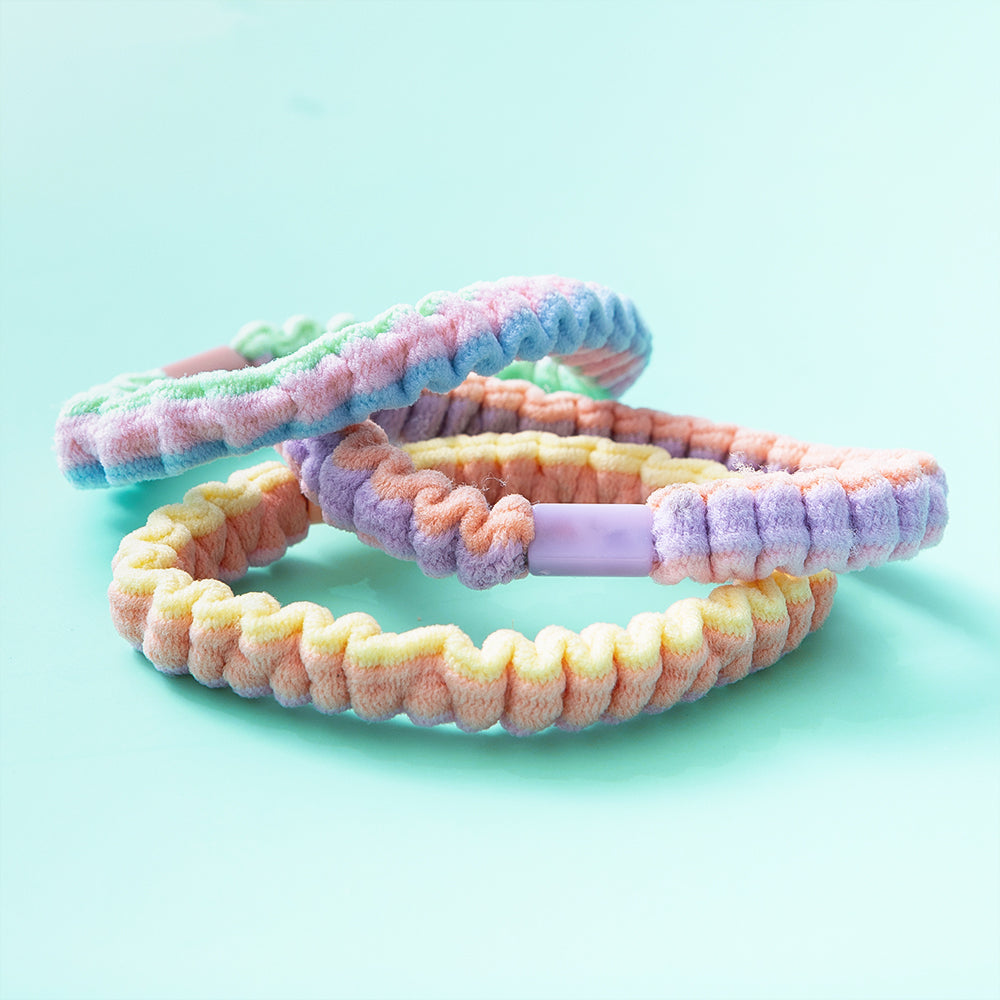 colorful hair tie sets on green