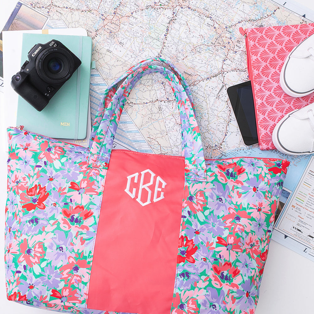 coral botanical packable weekend duffel over map 