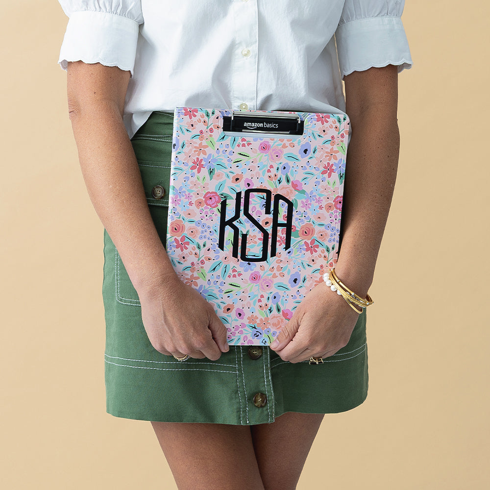 coral floral clipboard held closed by woman