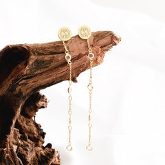 crystal duster earrings hanging on driftwood