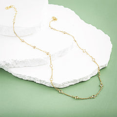 crystal station necklace on marble and green