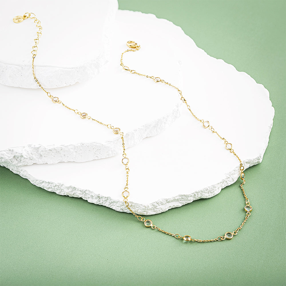 crystal station necklace on marble and green