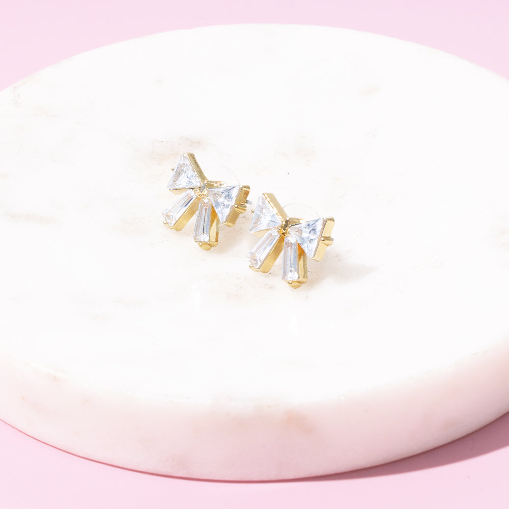 crystal bow earrings on marble
