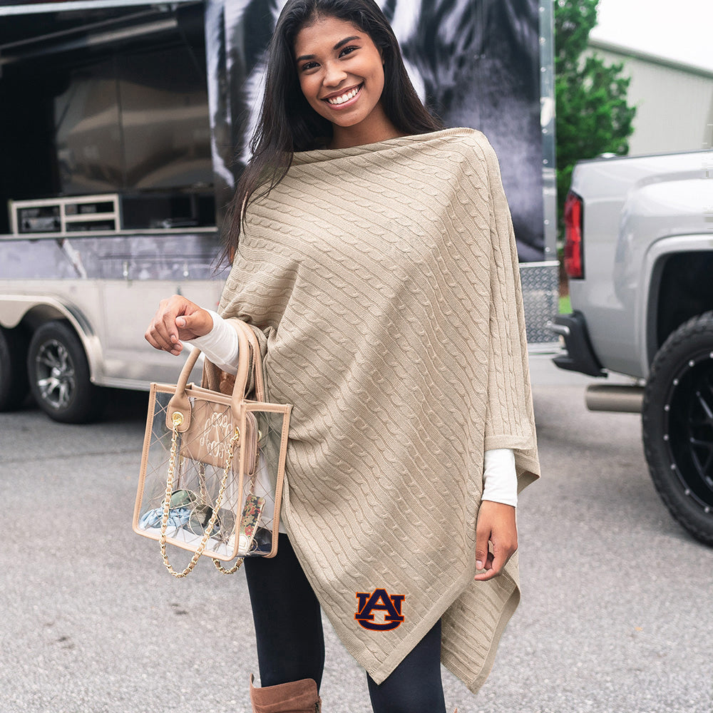 girl wearing camel auburn logo poncho