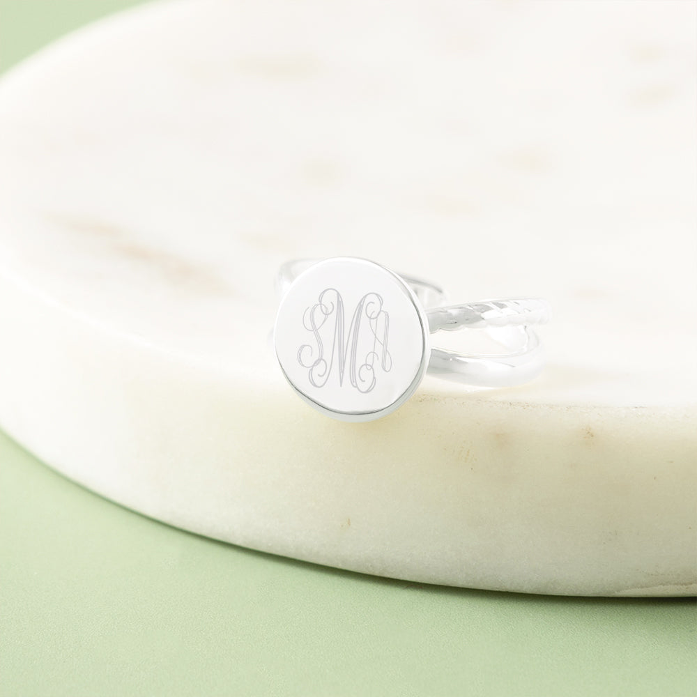 silver criss cross ring in marble dish
