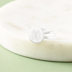silver criss cross ring in marble dish