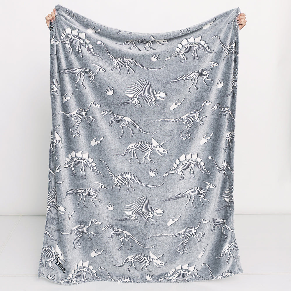 dinosaurs skeletons personalized kids plush blanket held up 