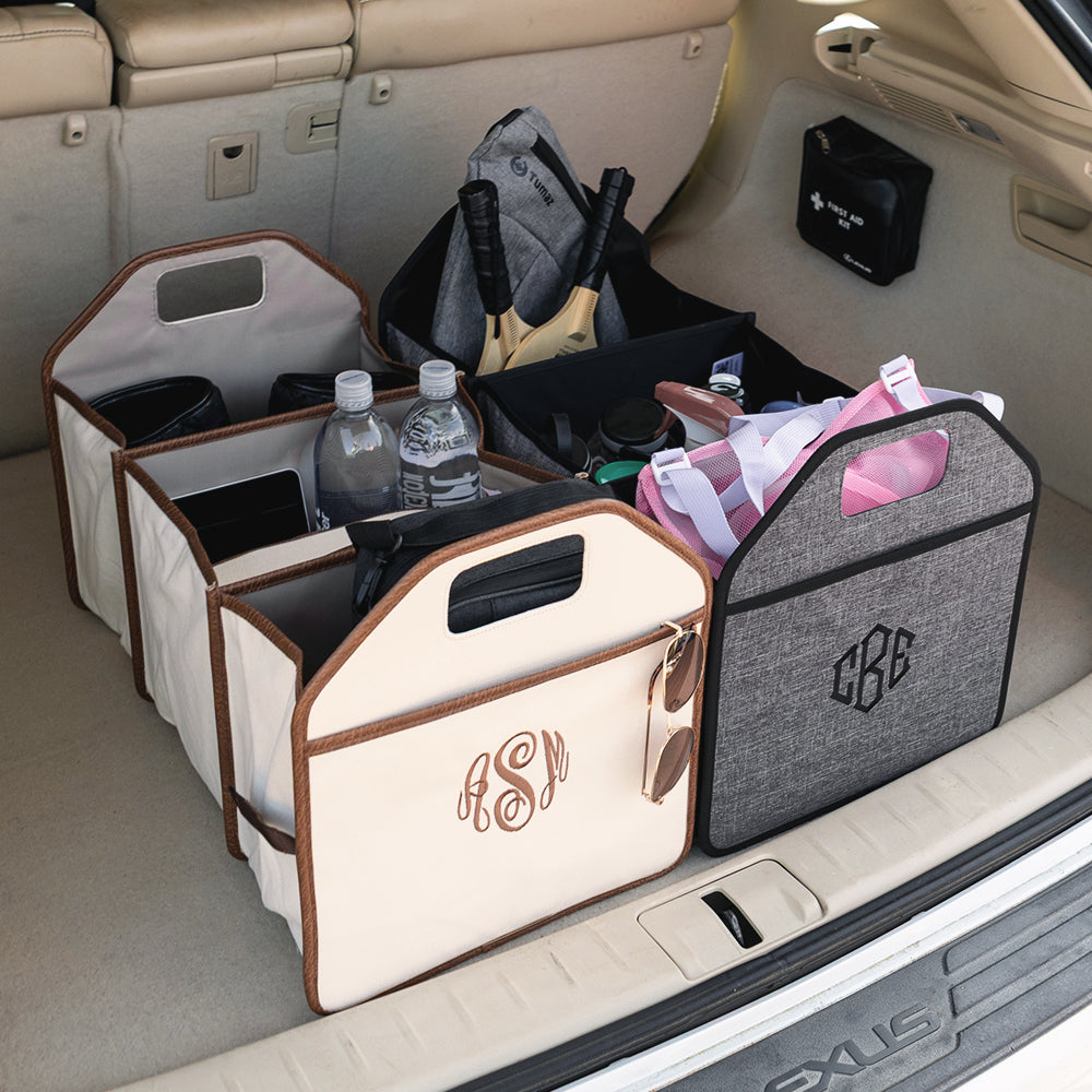 Two trunk organizers with monogrammed bins and personal items inside