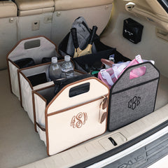 Two trunk organizers with monogrammed bins and personal items inside