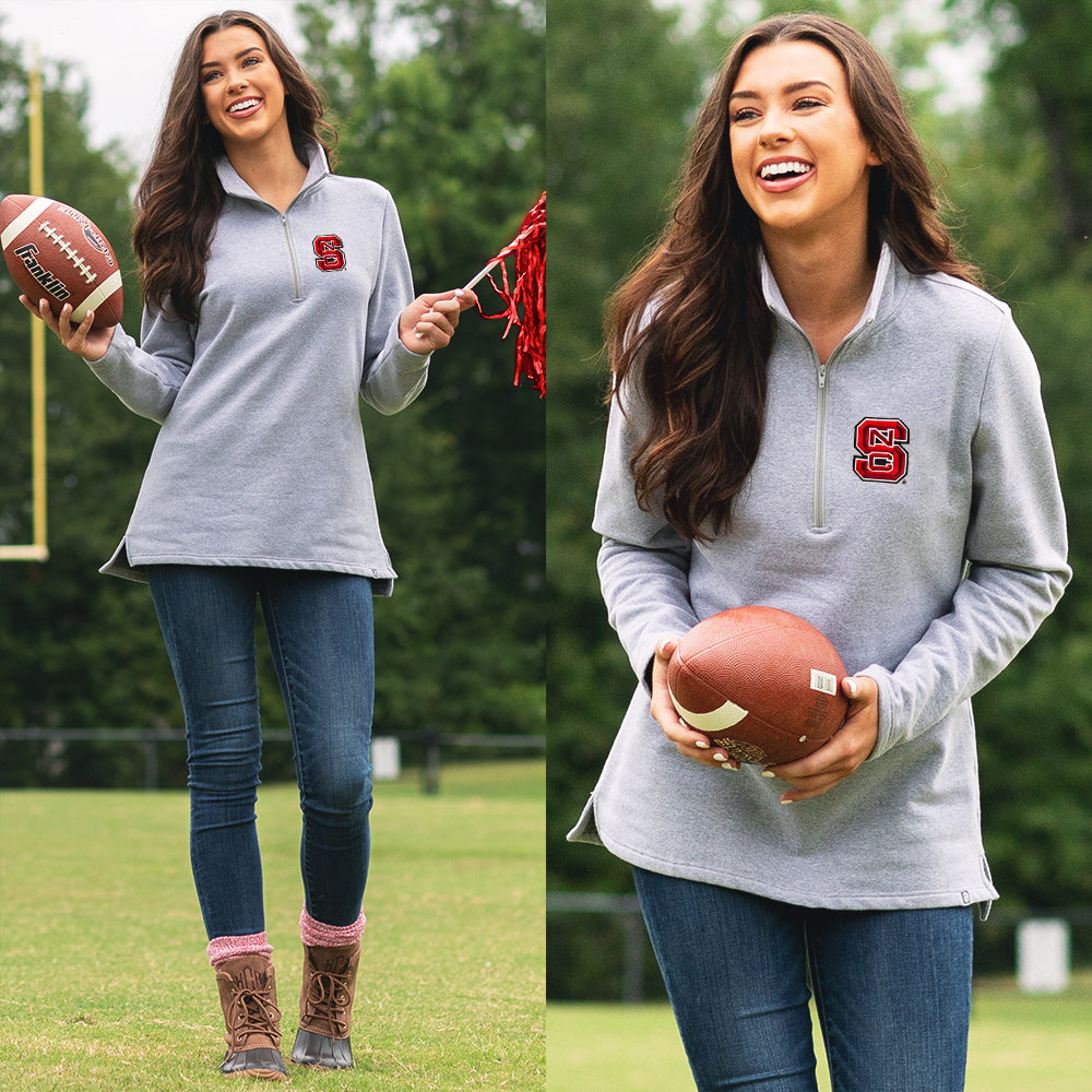 [tori] girl on football field wearing nc state pullover sweatshirt with duck boots and jeans