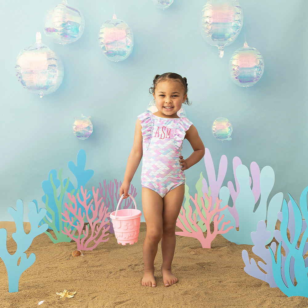 Girl wearing ruffle bathing suit in mermaid