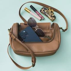 pockets in monogrammed crossbody bag in brown