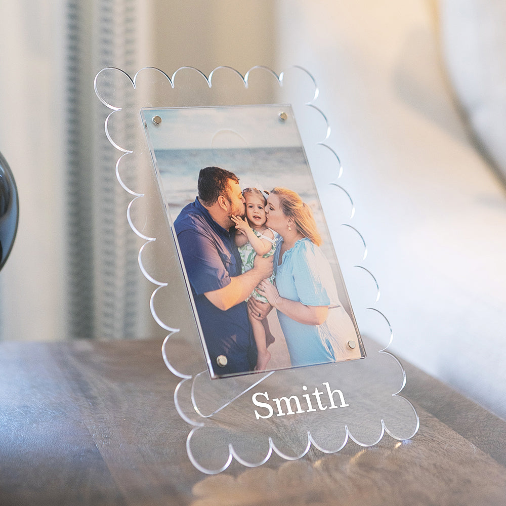 family photo in vinyl scalloped picture frame on nightstand 