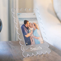 family photo in vinyl scalloped picture frame on nightstand 