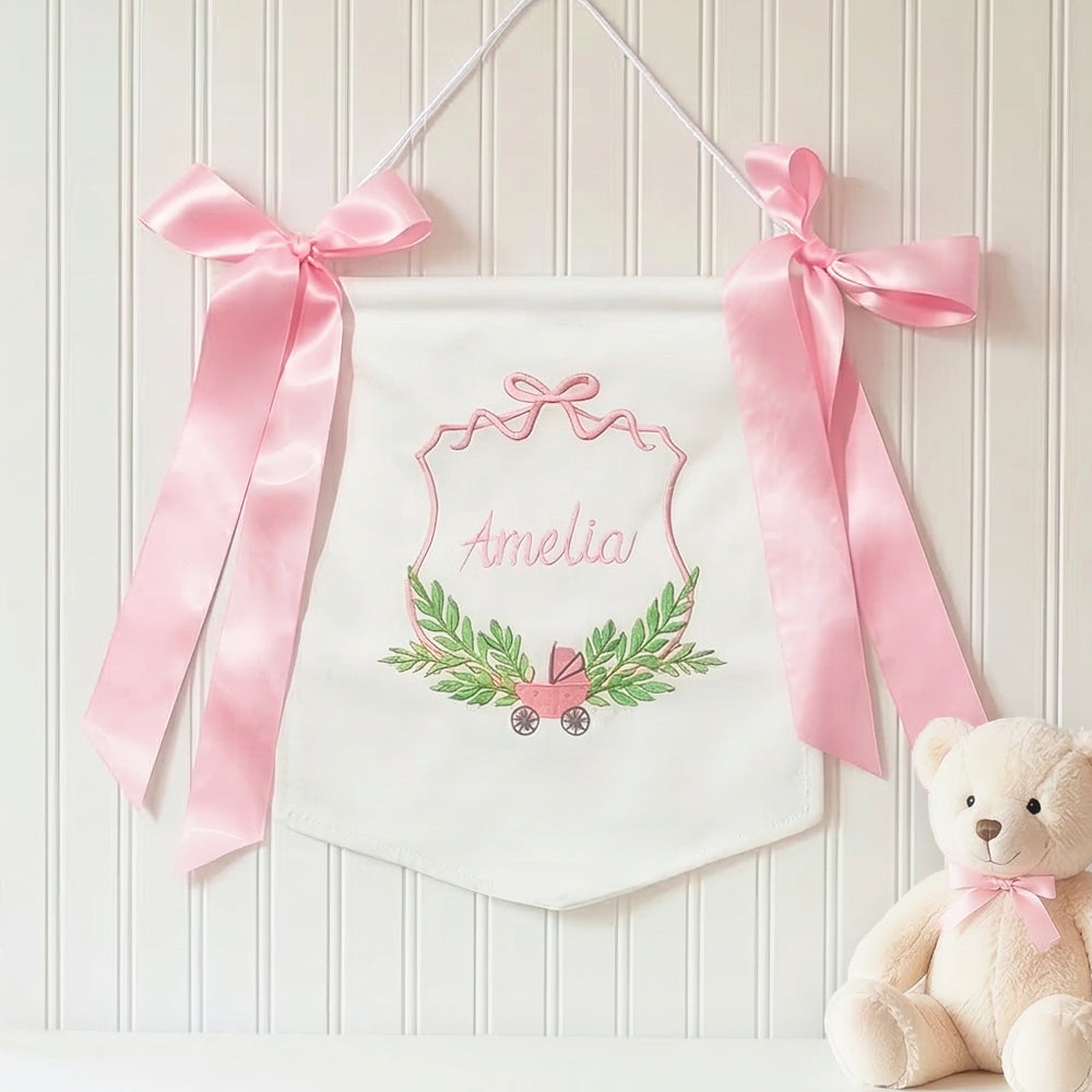 pink new baby banner on wall