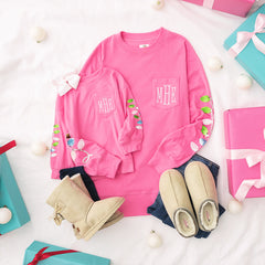 mom and me christmas sweaters in hot pink flatlay