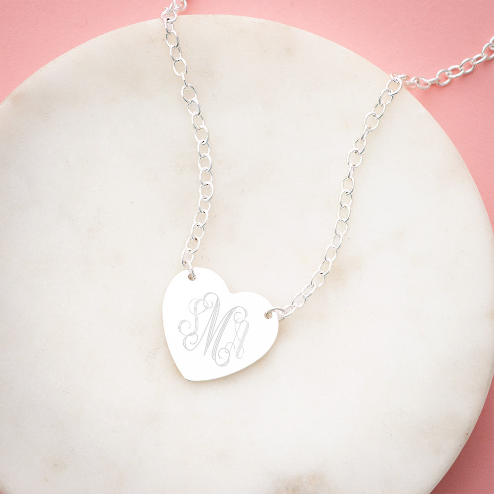 silver heart pendant necklace on marble dish