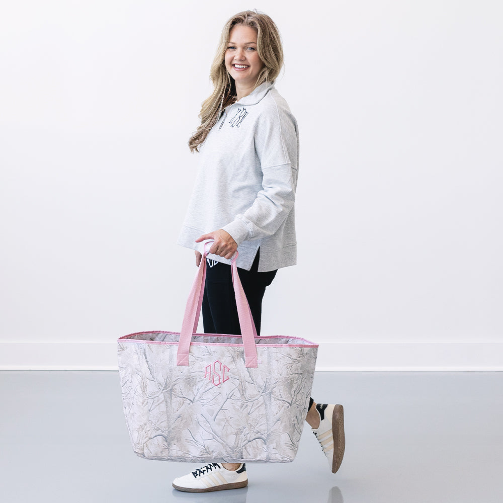 girl carrying monogrammed extra large tote bag in birch camo 