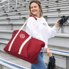 girl carrying monogrammed extra large tote bag in red in football stadium