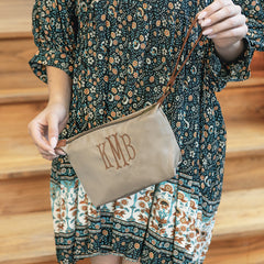 girl carrying monogrammed lightweight wristlet in tan 