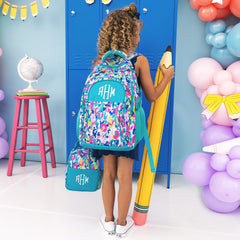 girl carrying monogrammed lunch box and backpack in watercolor cheetah