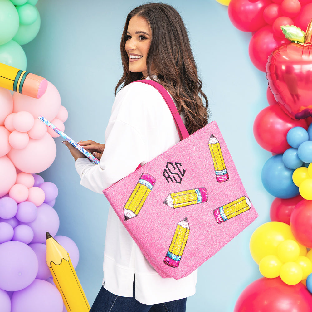 girl carrying monogrammed sequin tote bag in pink pencils 