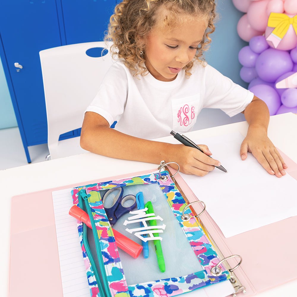 girl drawing next to personalized binder pouch in watercolor cheetah 