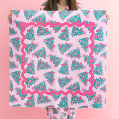girl holding monogrammed mahjong mat in pink christmas trees 