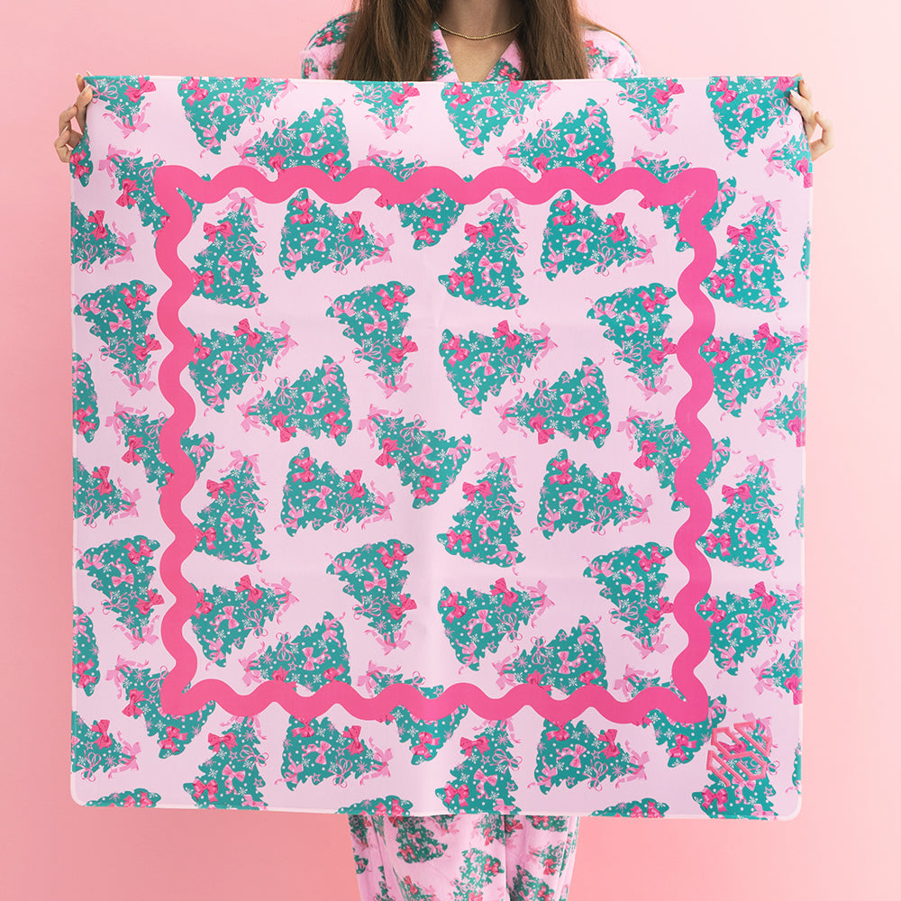 girl holding monogrammed mahjong mat in pink christmas trees 