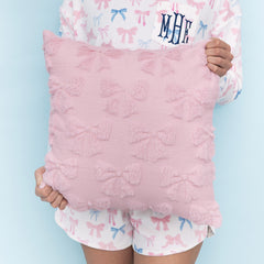 girl holding pink bow pillow sham