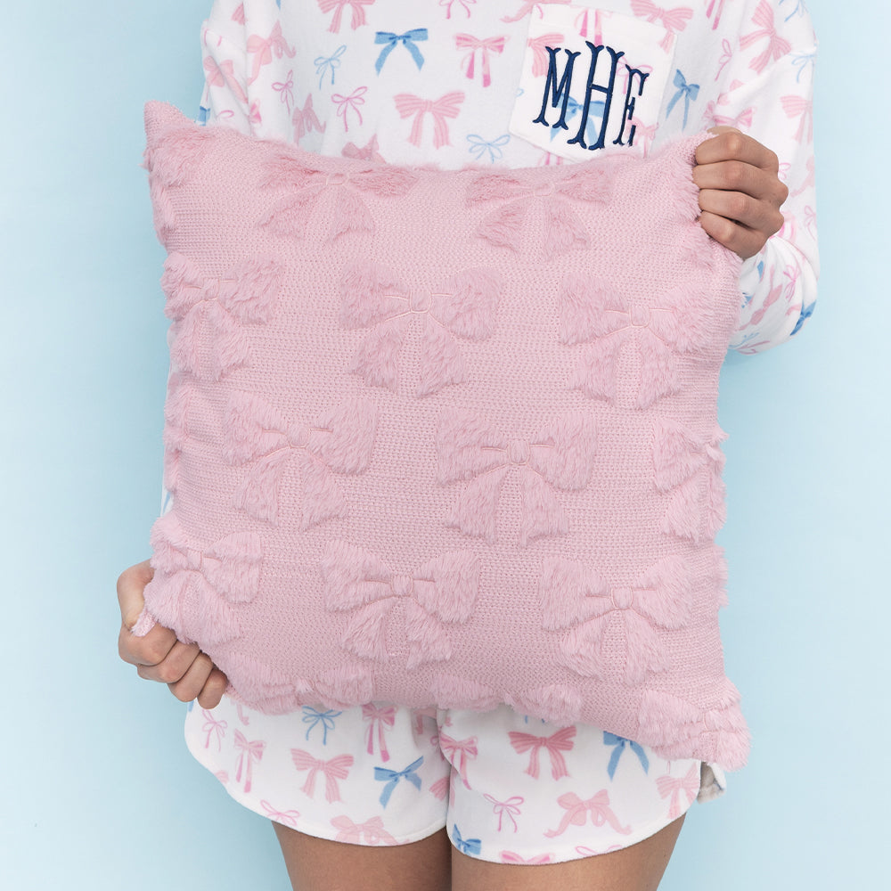 girl holding pink bow pillow sham