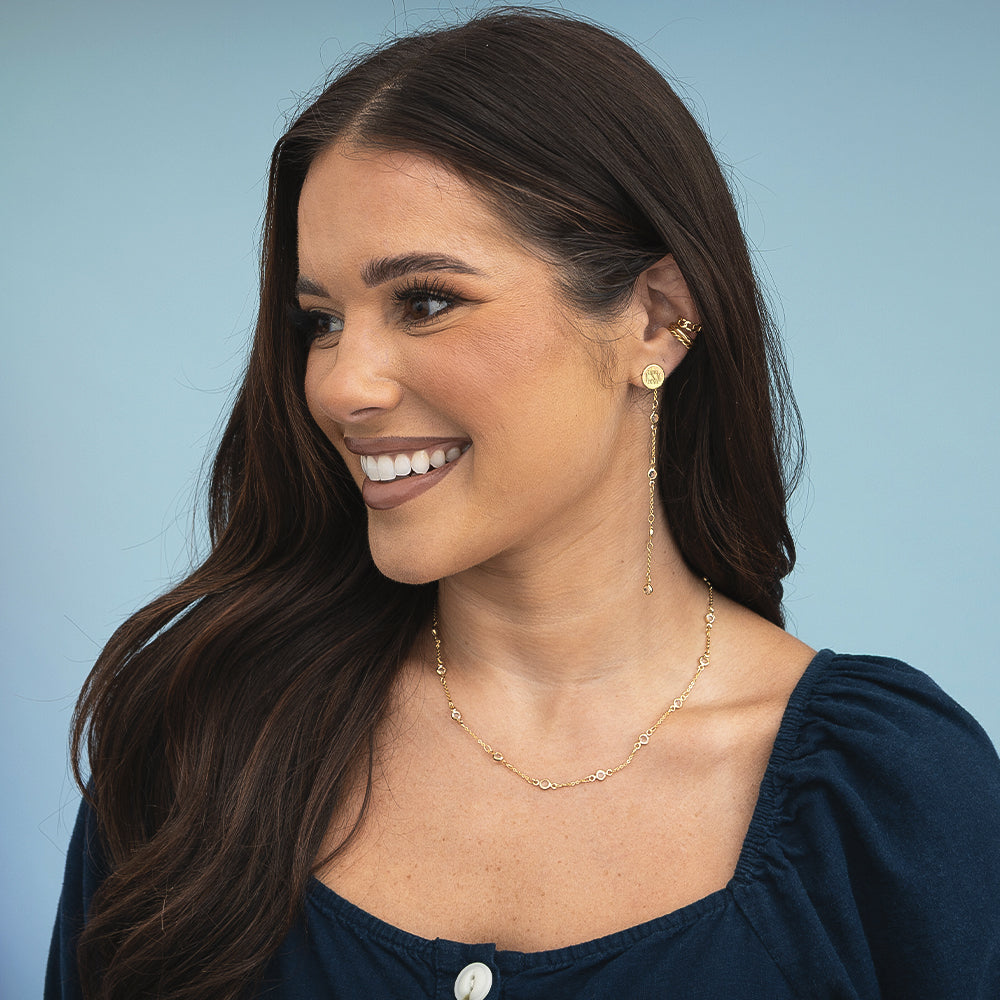 girl wearing crystal station necklace and earrings