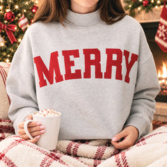 girl wearing heathered gray merry mockneck sweatshirt with hot chocolate 