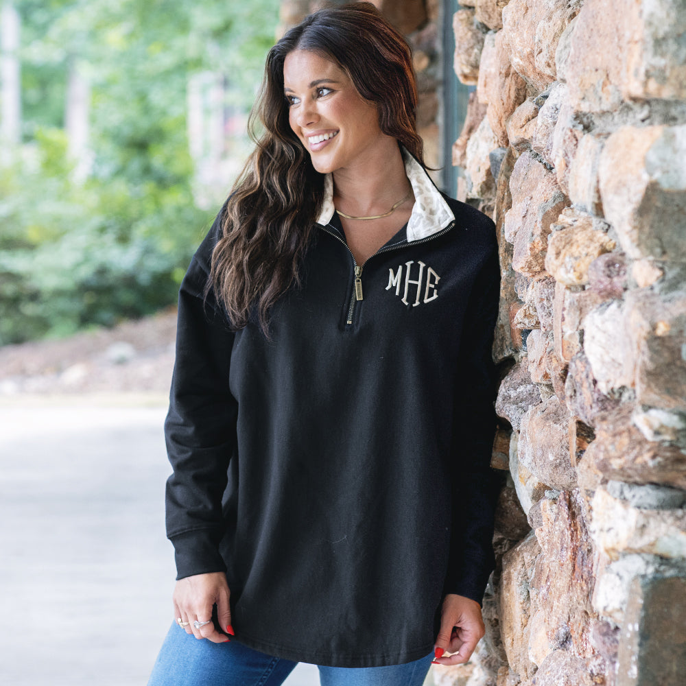 girl wearing luxe leopard monogrammed quarter zip sweatshirt outside 