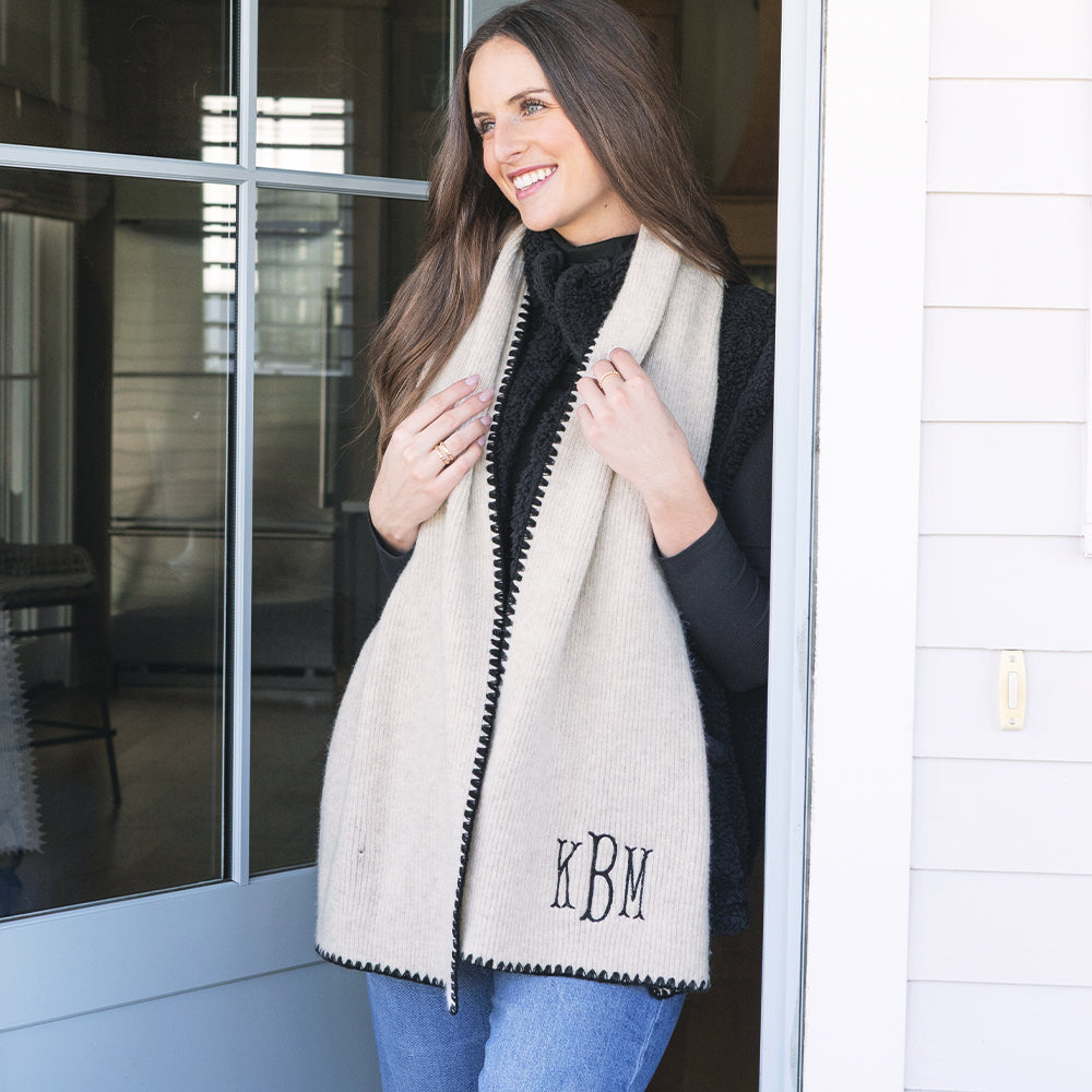 girl wearing monogrammed embroidered edge scarf in ivory and black