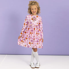girl wearing monogrammed girls twirl dress in pretty pumpkins 