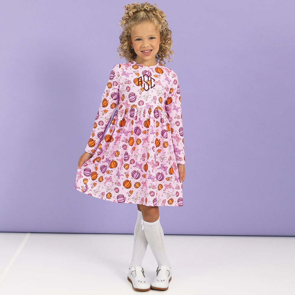 girl wearing monogrammed girls twirl dress in pretty pumpkins 