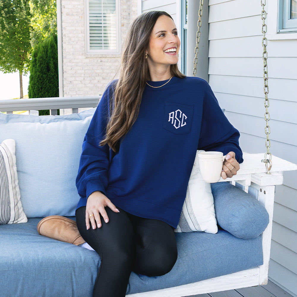 girl wearing navy oversized sweatshirt on swing